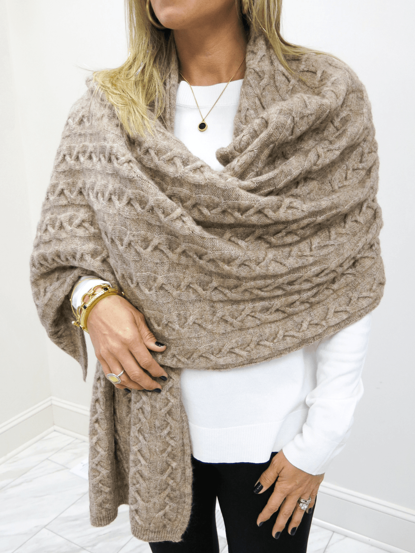 Front view of taupe Kerisma sweater wrap around shoulders.