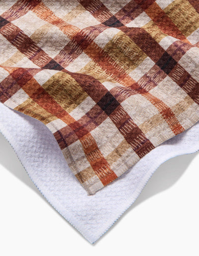 Plaid tea towel with brown and beige colors on a white background closeup