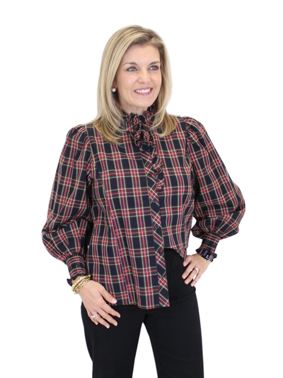 Woman wearing a plaid blouse with a white background