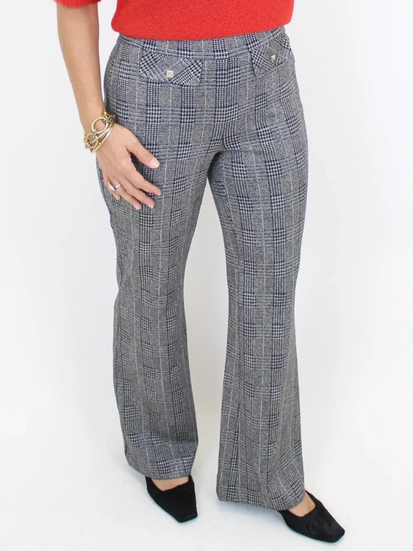 Charcoal plaid pants up close on model.