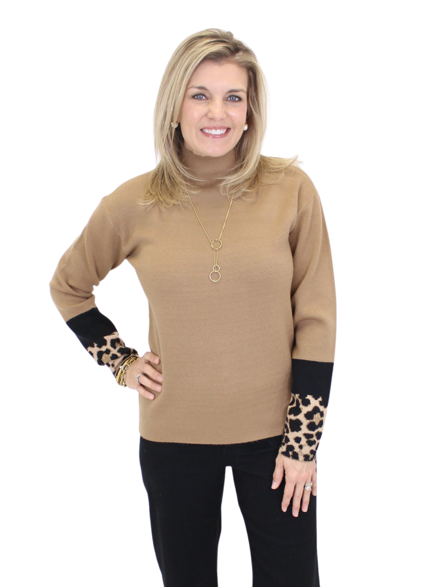 Woman wearing a beige turtleneck sweater with leopard print cuffs on a white background
