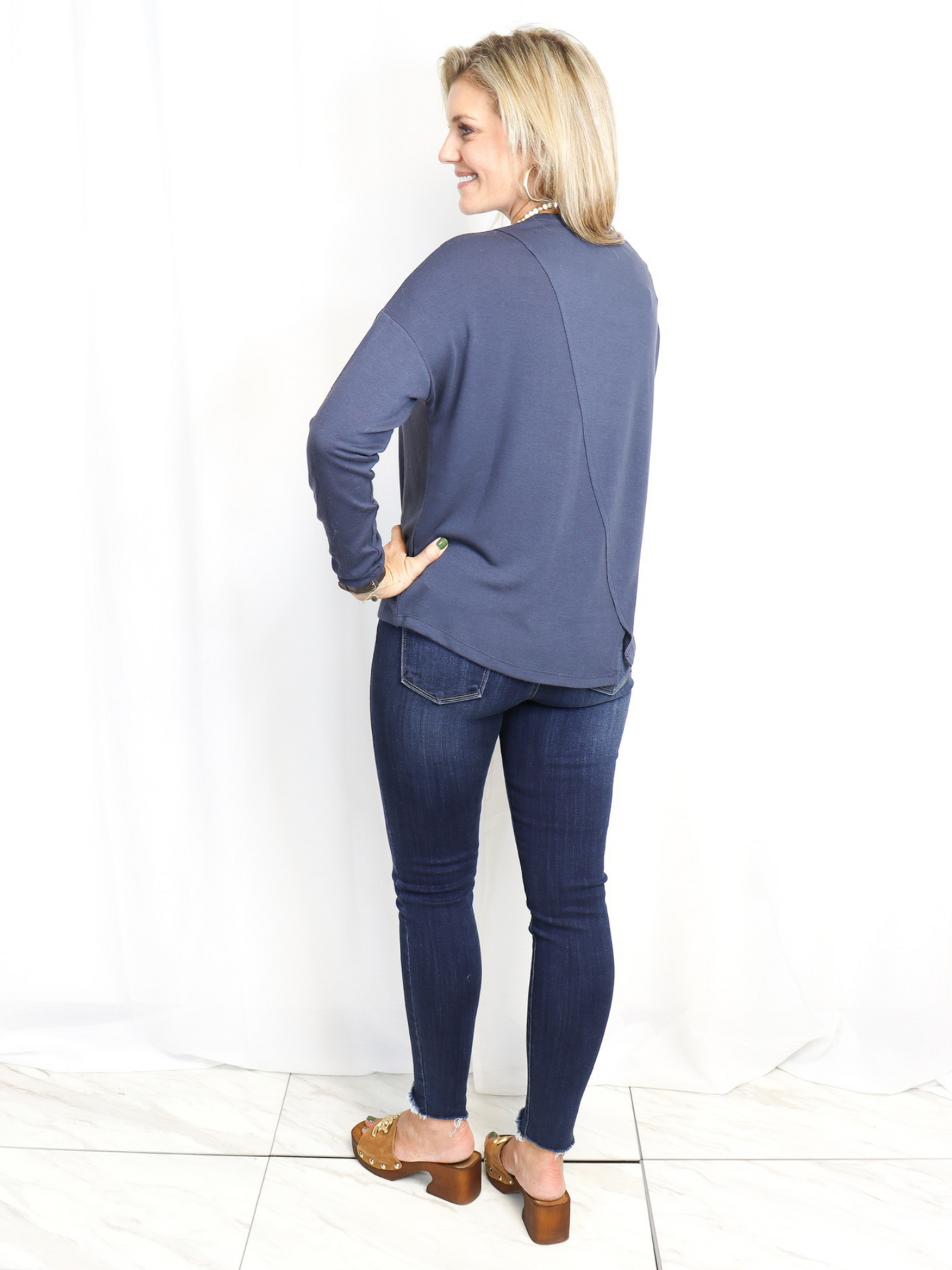 Asymmetrical Knit Top with jeans back view.