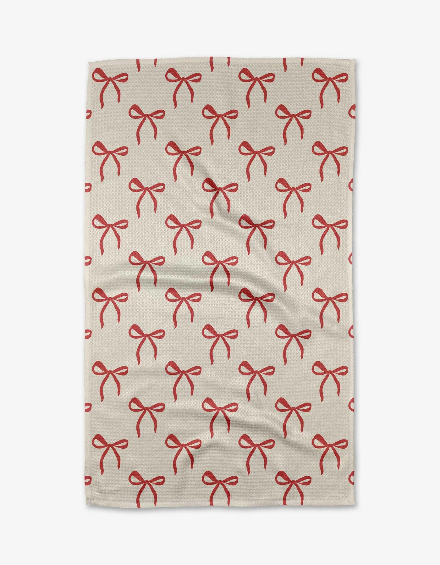 Cream tea towel with red bow pattern on a white background