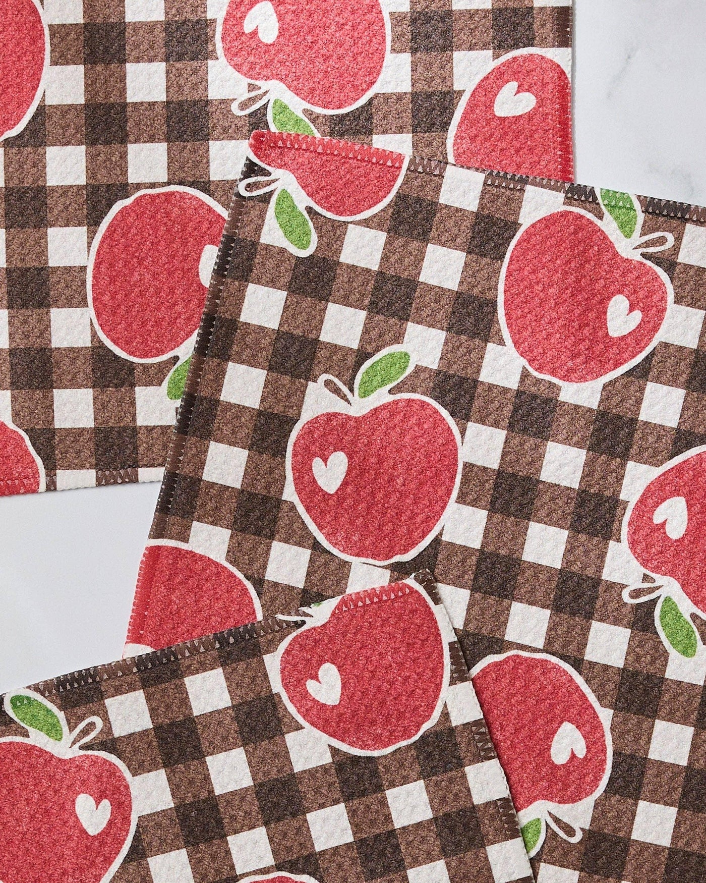 Checkered fabric with red apple pattern