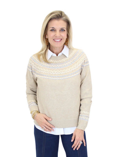 Woman wearing a beige sweater with a white collar on a white background