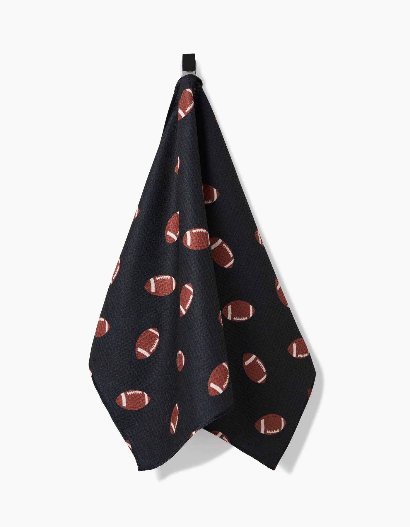 Black towel with football pattern hanging on a white background