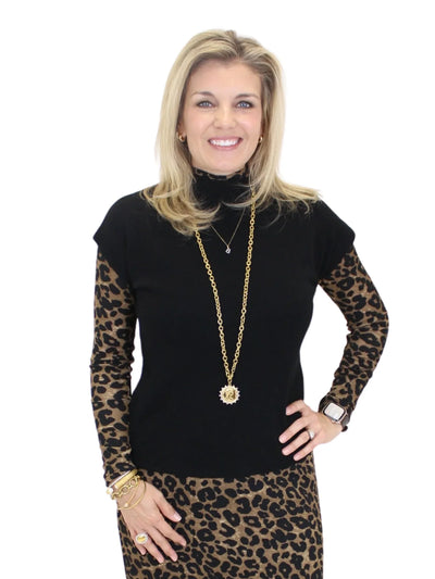 Molly Bracken Short Sleeve Mock Neck Sweater - Black front view over a leopard top.