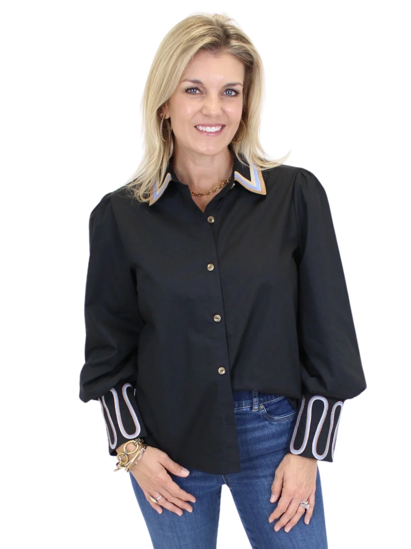 Beth is wearing a black western blouse.