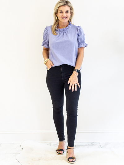 Blue Ruffle Neck Poplin Top paired with black jeans and wedges.