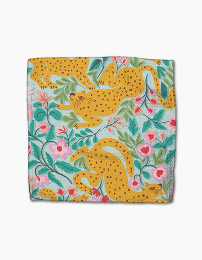 Green dishcloth with pink florals and cheetahs on a white background
