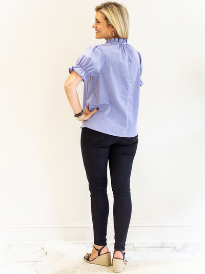 Blue Ruffle Neck Poplin Top back view with black jeans.