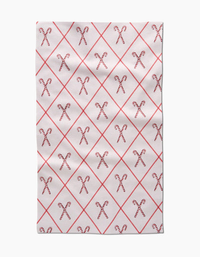 Cream tea towel with red diamond stripe and candy cane pattern on white background