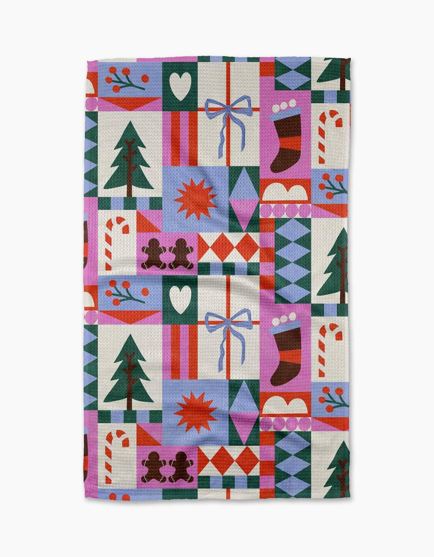 Colorful quilt-style patterned tea towel with Christmas-themed designs on a white background
