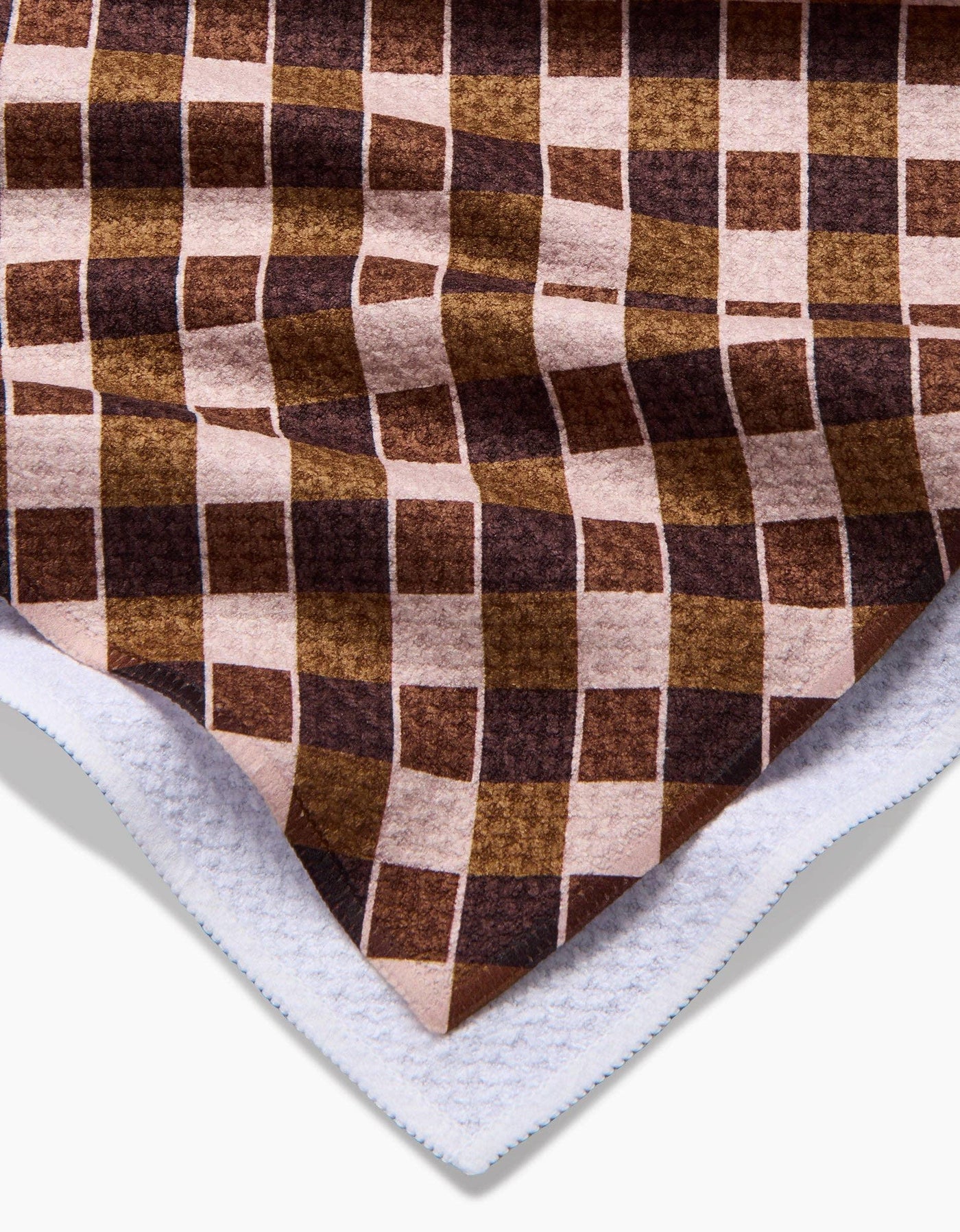 Checkered fabric with brown and beige pattern on a white background