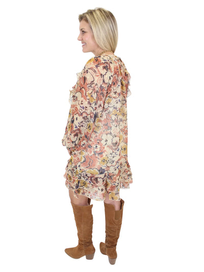 Woman wearing a floral dress and brown knee-high boots on a white background