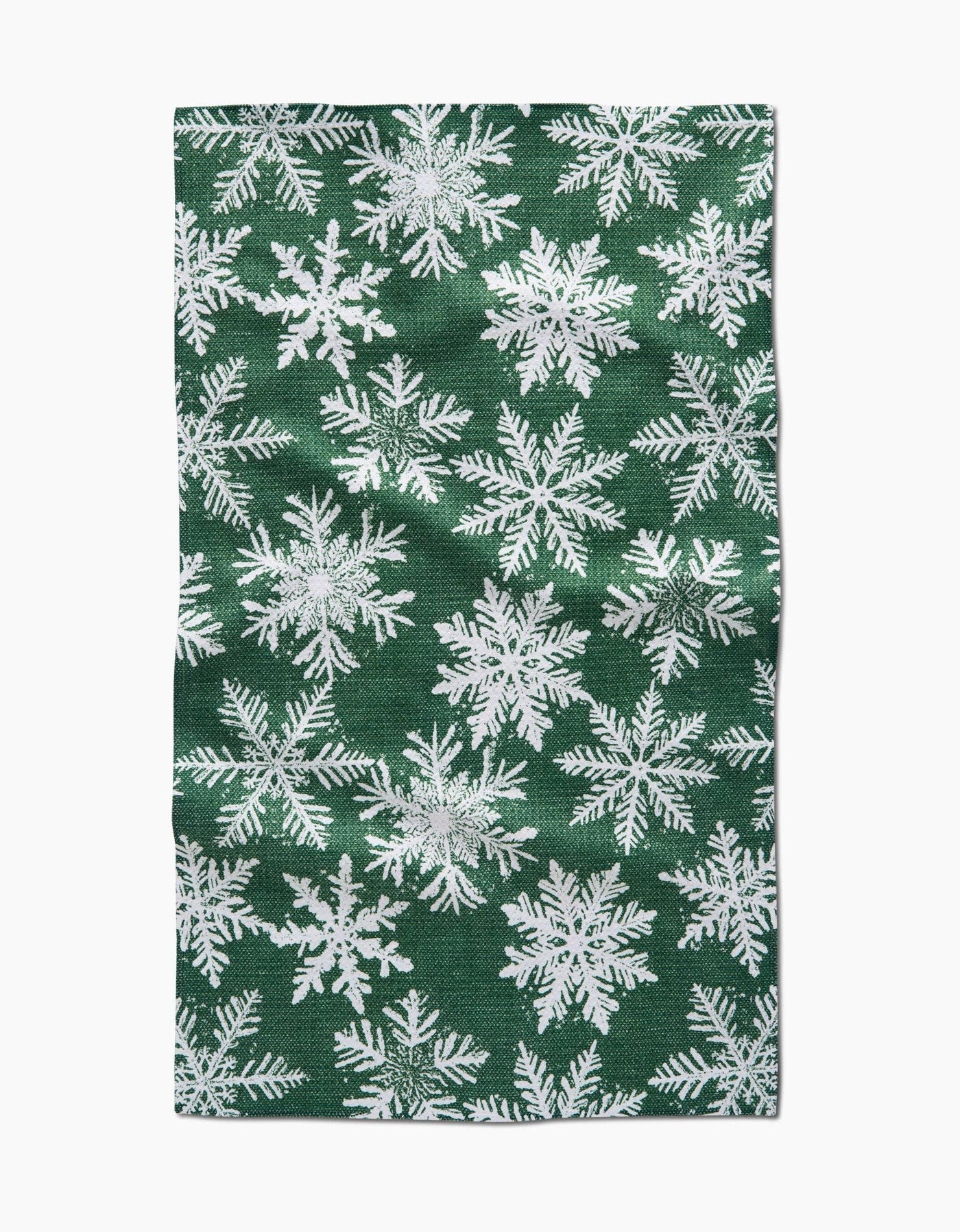 Green tea towel with white snowflake pattern.