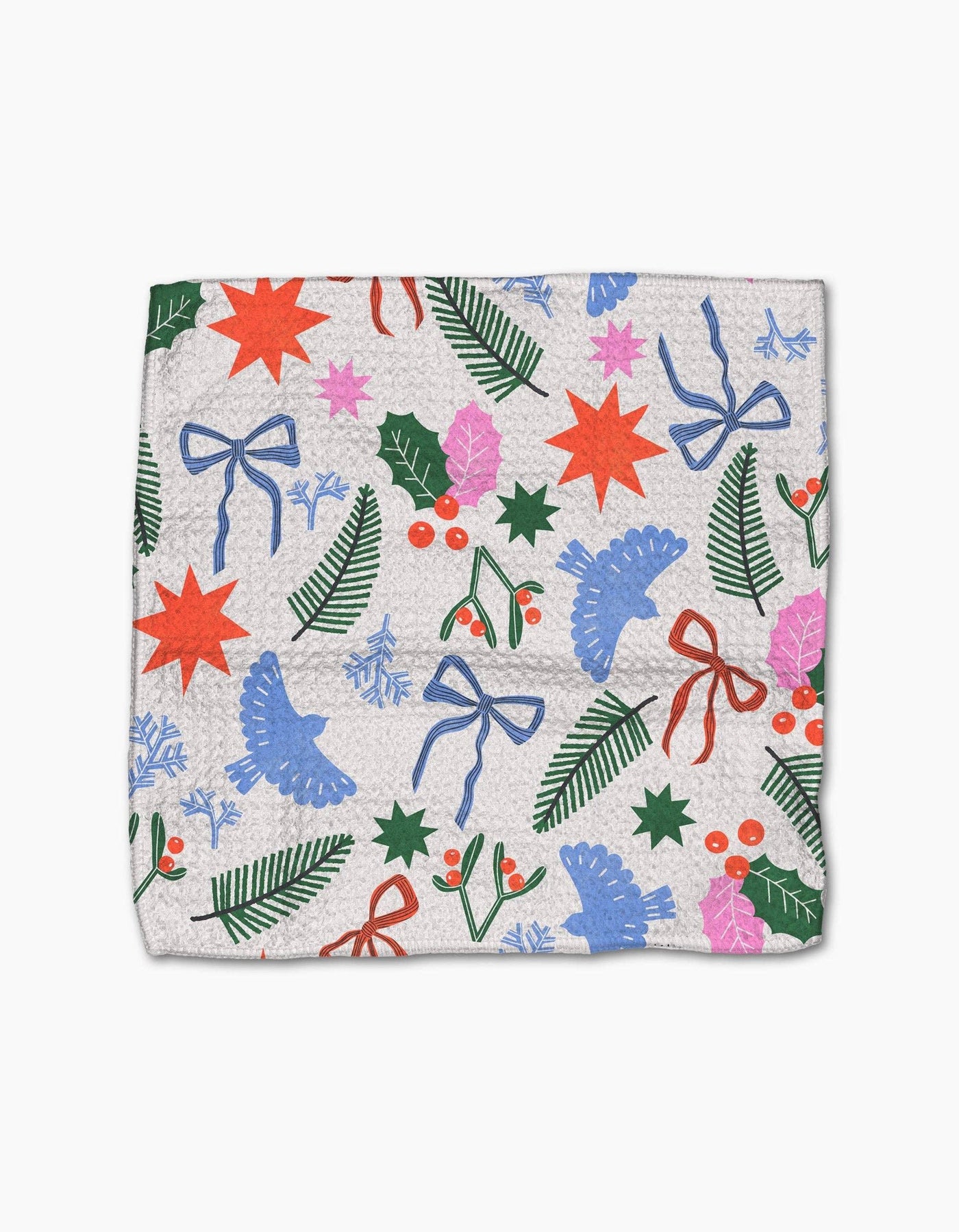 Dishcloth with festive pattern featuring stars, bows, and holly on a white background