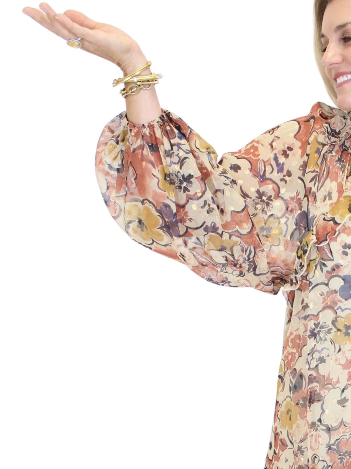 Woman wearing a floral blouse with long sleeves on a white background