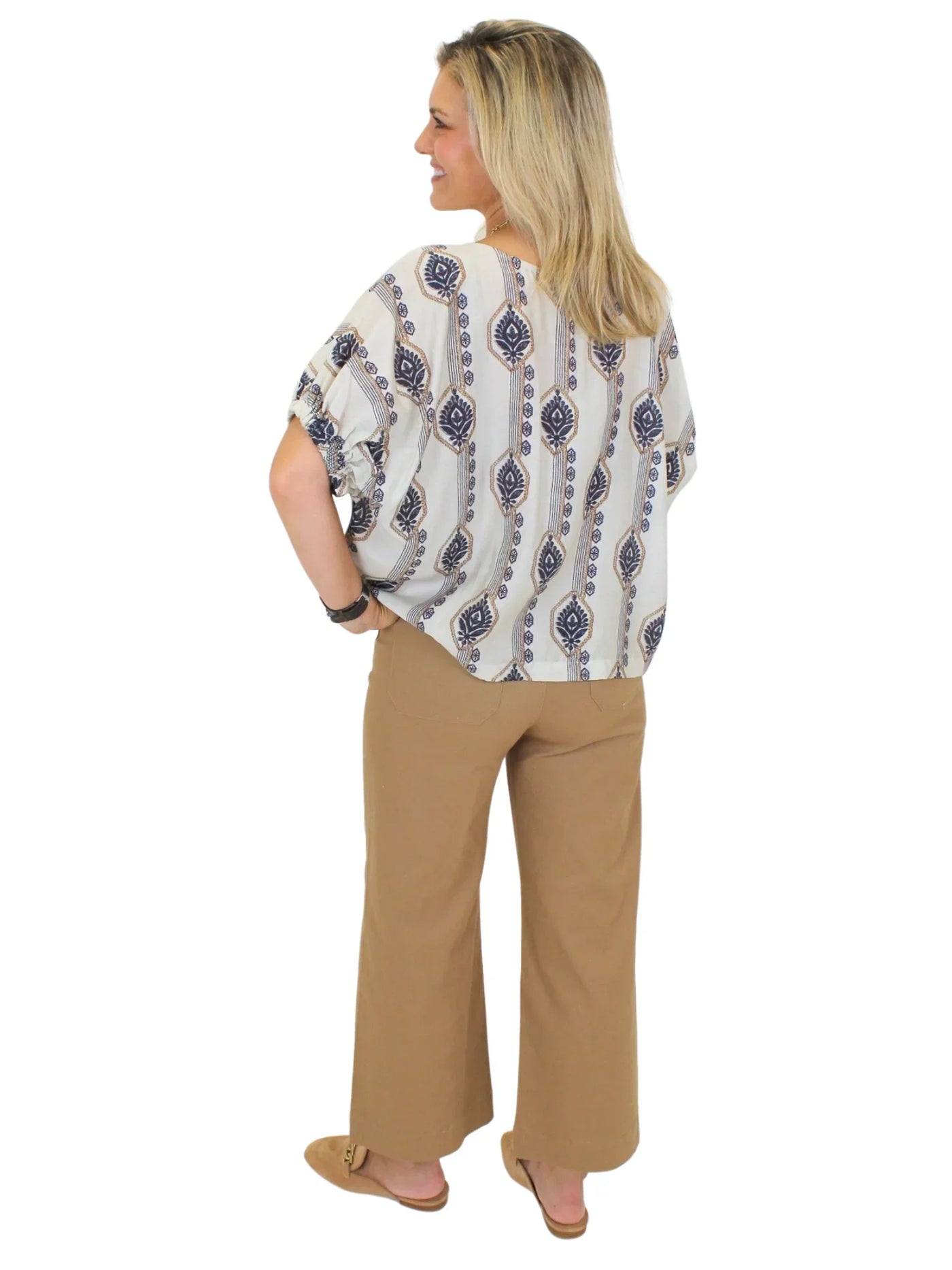 Tan cropped wide leg pants on model on white background, back.