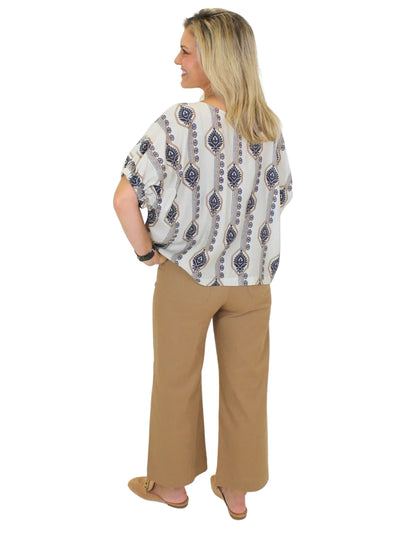 Tan cropped wide leg pants on model on white background, back.