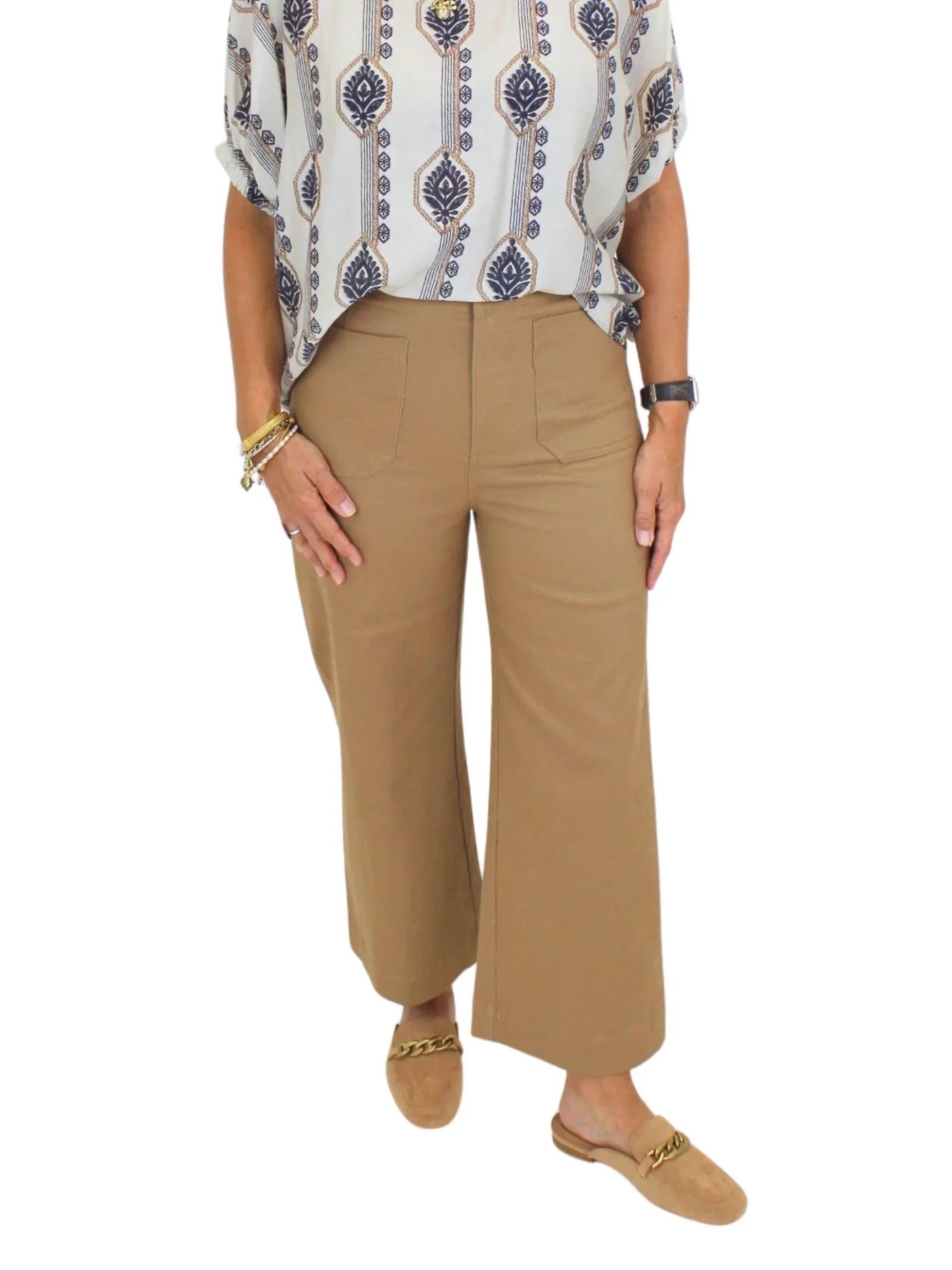 Tan cropped wide leg pants on model on white background, closeup front.