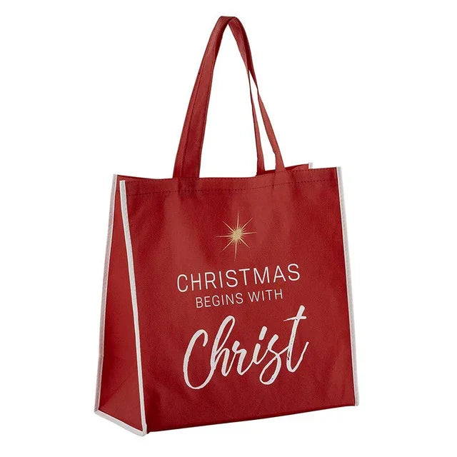 Red tote bag with 'Christmas Begins with Christ' text on a white background