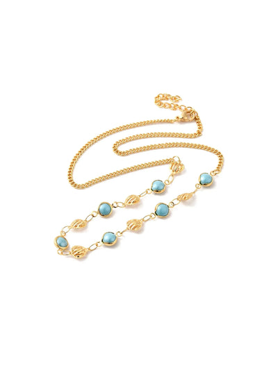 Gold necklace with turquoise and gold beads on white background.