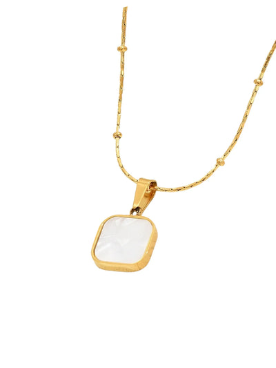 Gold necklace with a white square pendant on a white background