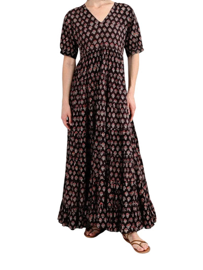 Model wearing brown floral printed maxi dress on white background, front.