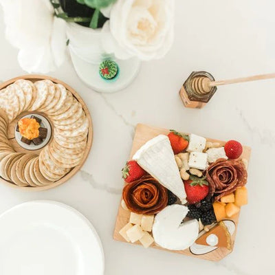 Maple Cheese Board by Nora Fleming shown with food.