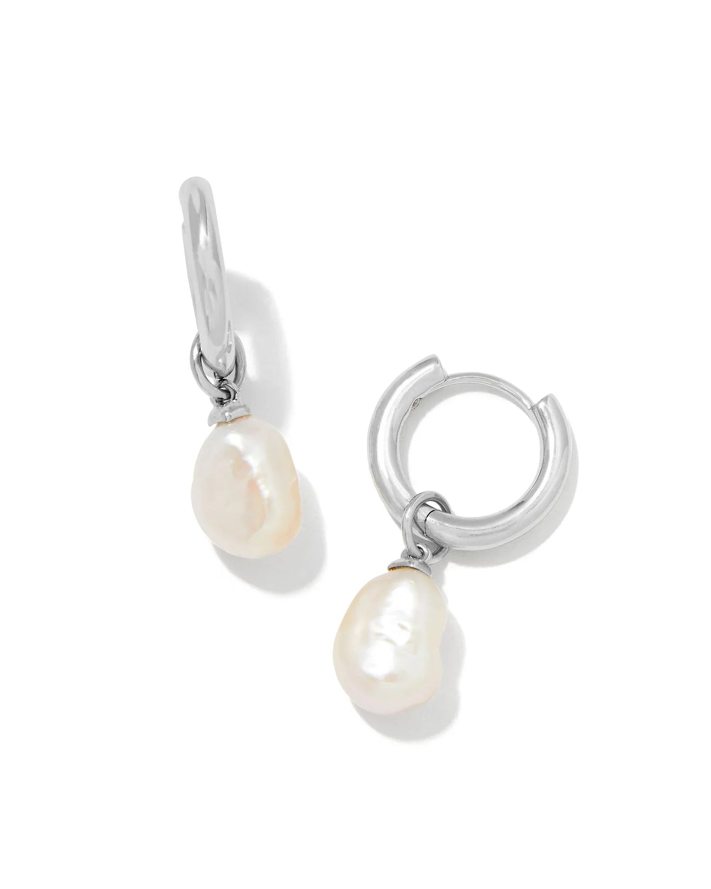 Silver hoop earrings with pearl drops on a white background.