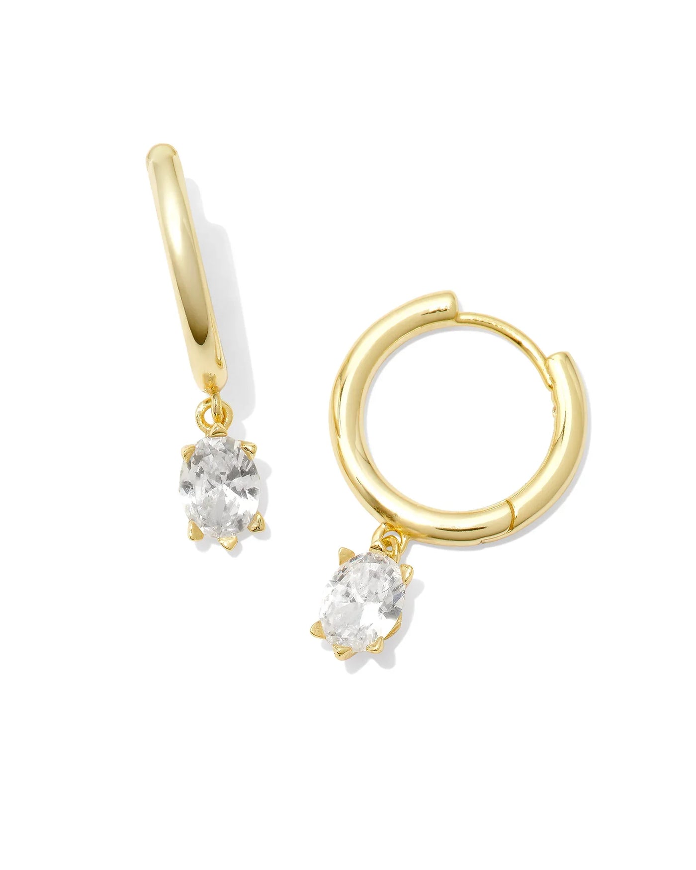 Gold hoop earrings with clear gemstones on a white background.