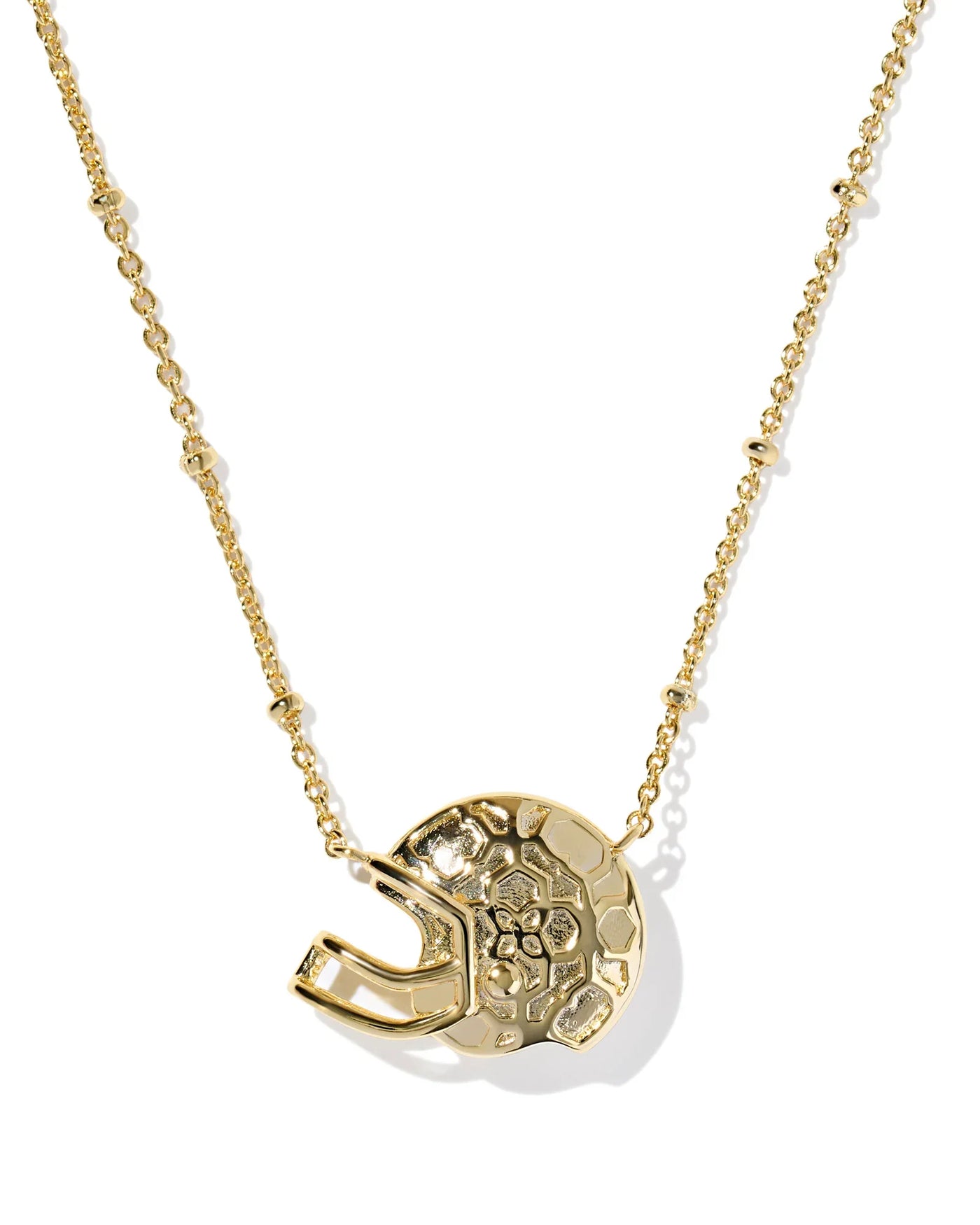 Gold necklace with football helmet pendant from the back, closeup.