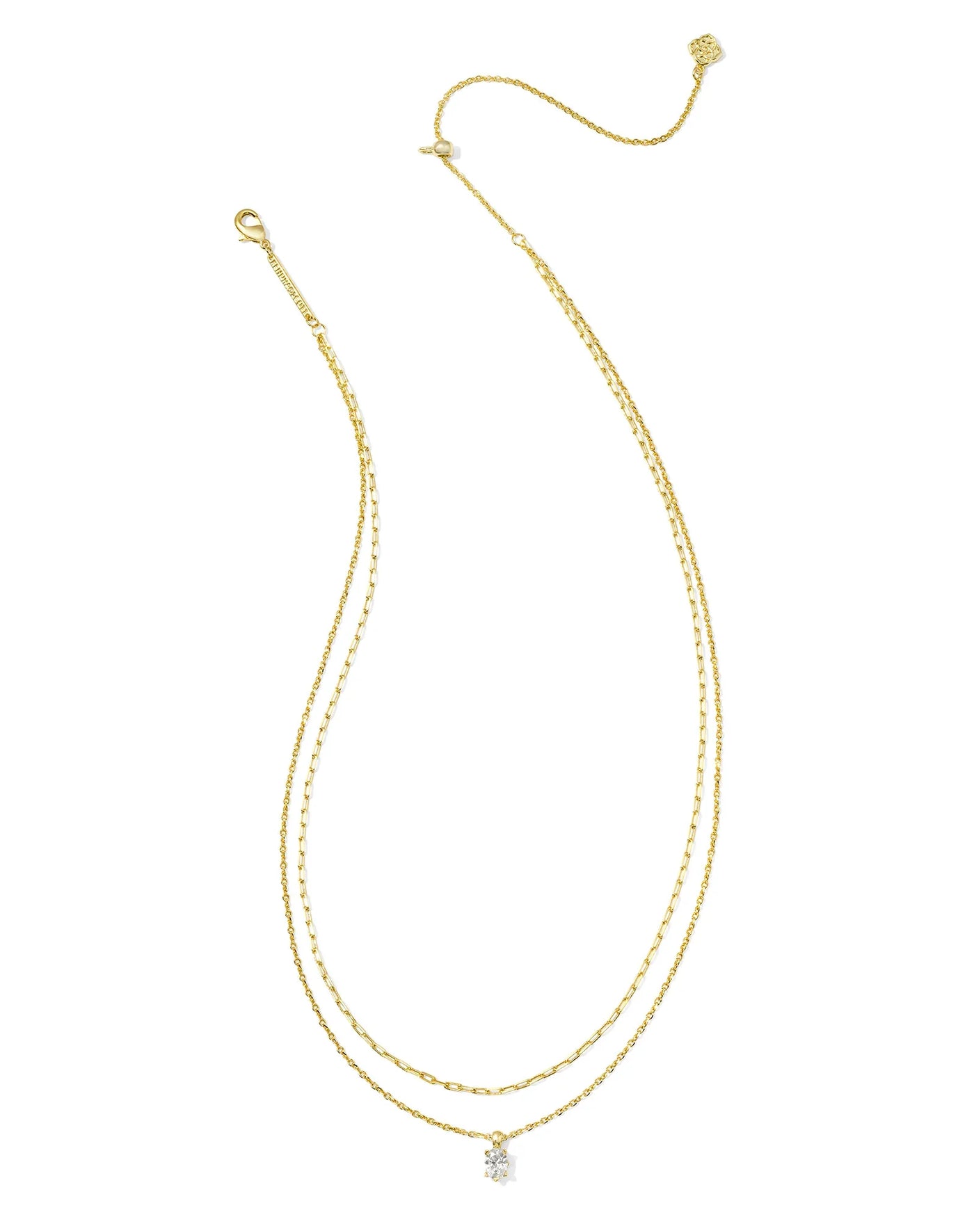 Gold multi strand necklace with crystal pendant on white background.