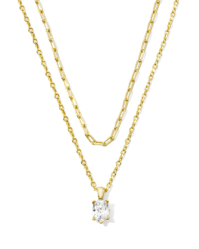 Two gold necklaces with a crystal pendant on a white background.