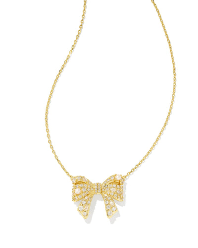 Gold necklace with bow pendant on white background.