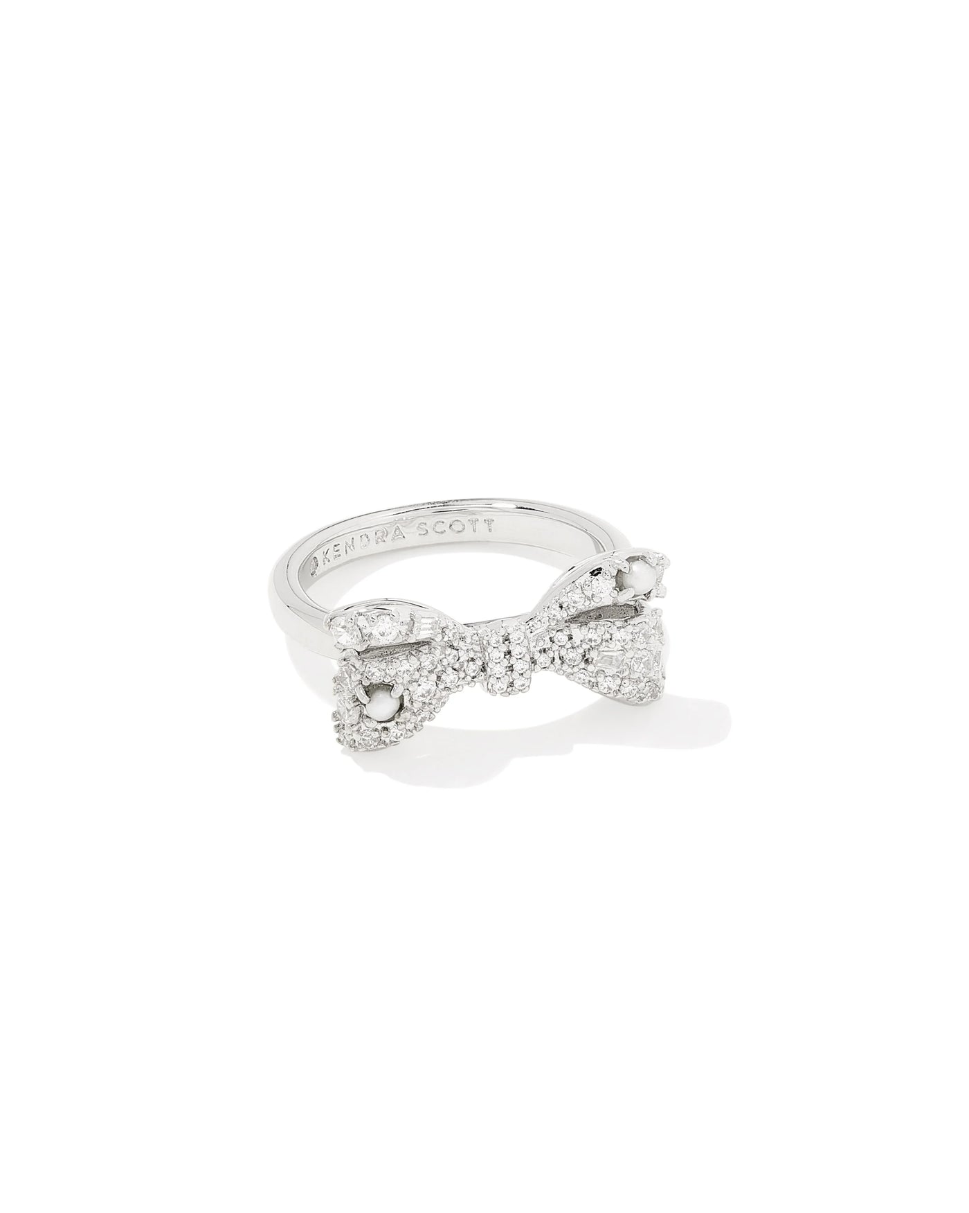 Silver bow-shaped ring on a white background.