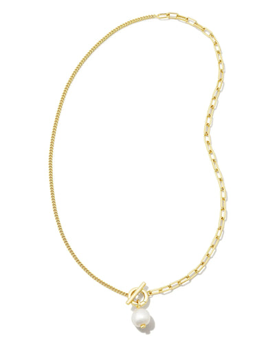 Gold necklace with a white pearl pendant on a white background.
