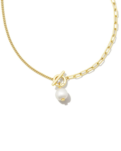 Gold necklace with a pearl pendant on a white background.