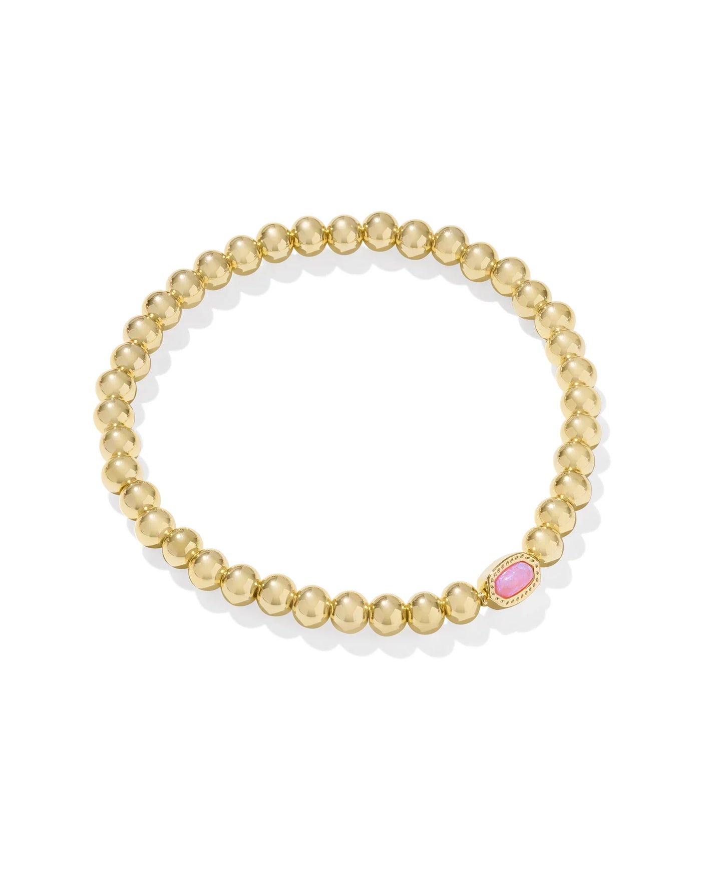 Gold bracelet with pink opal enter stone on white background.