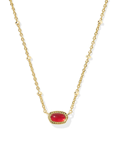 Gold necklace with a red gemstone on a white background, closeup.