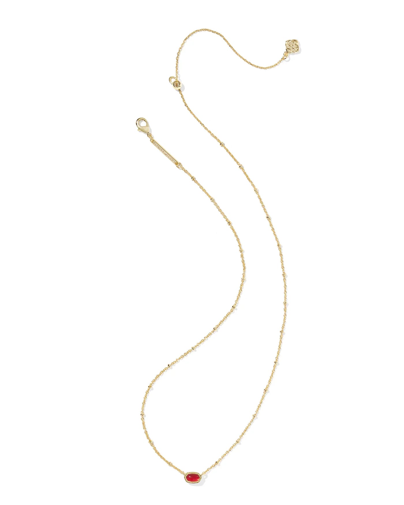 Gold necklace with a red pendant on a white background