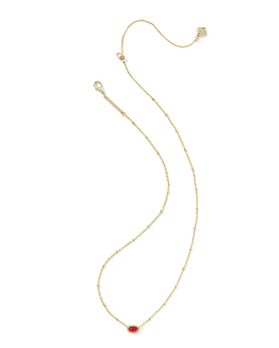 Gold necklace with a red pendant on a white background