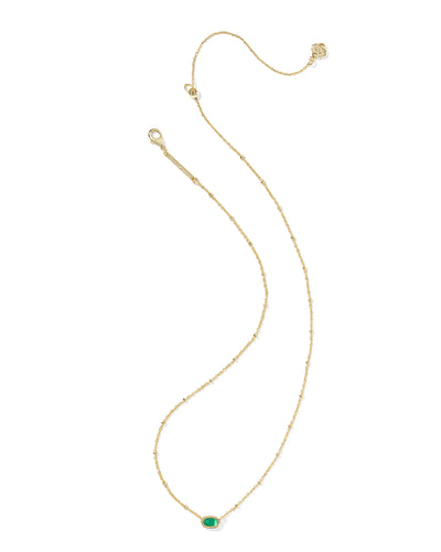 Gold necklace with a green gemstone on a white background