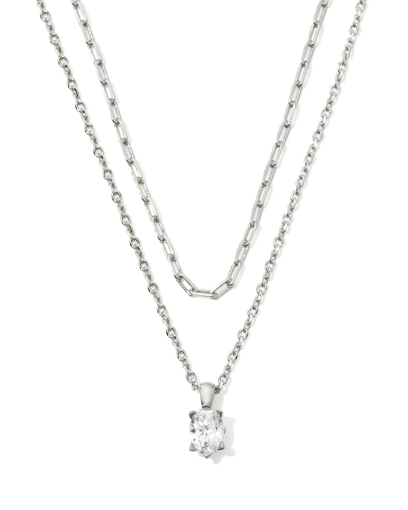 Silver two-strand necklace with crystal pendant on white background.