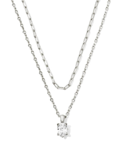 Silver two-strand necklace with crystal pendant on white background.