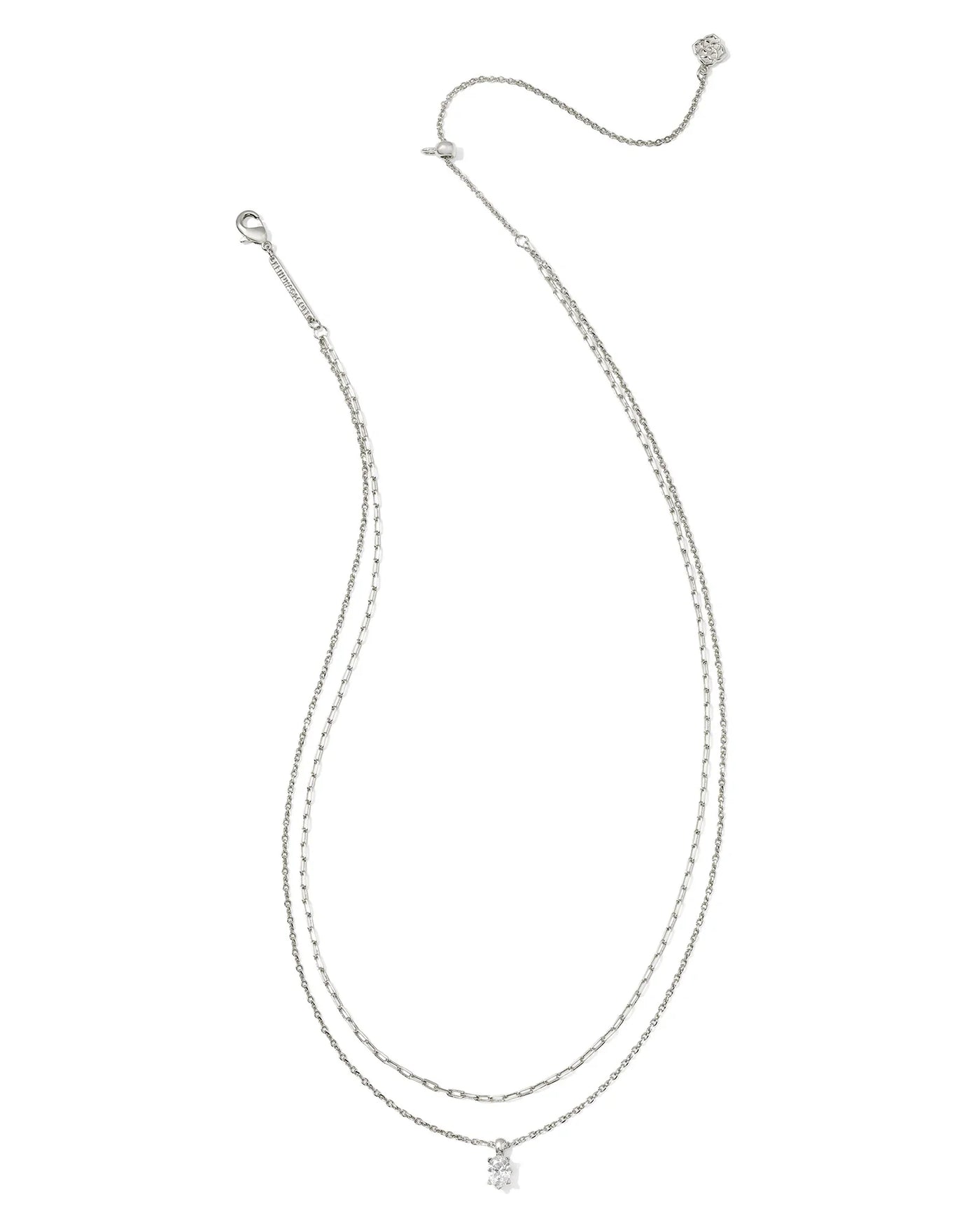 Silver multi strand necklace with a small crystal pendant on a white background.
