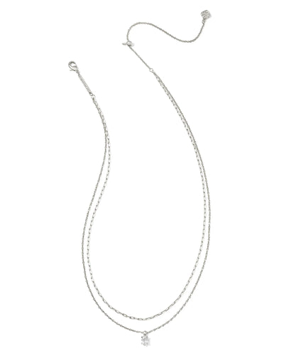 Silver multi strand necklace with a small crystal pendant on a white background.