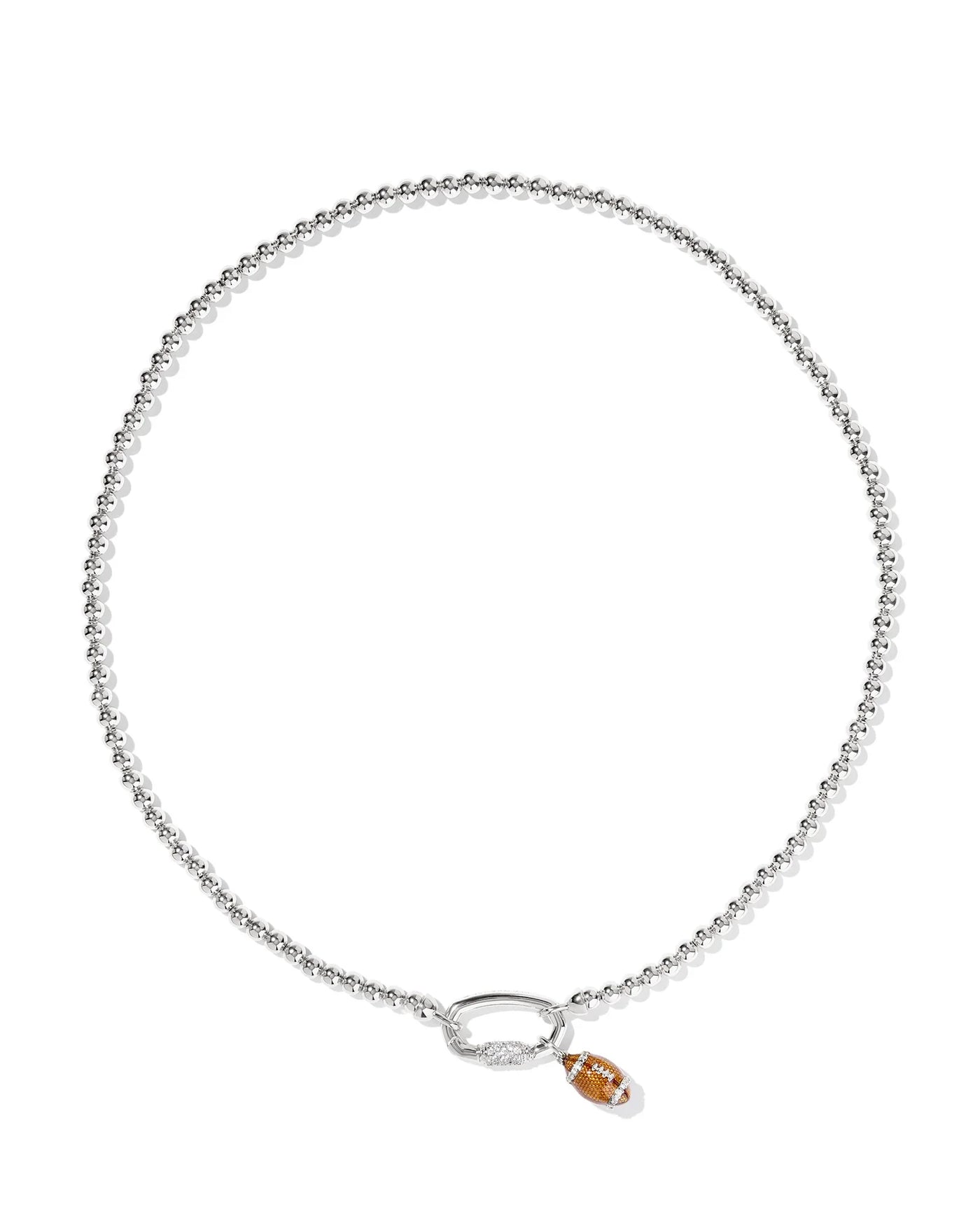 Silver necklace with a small football pendant on a white background.