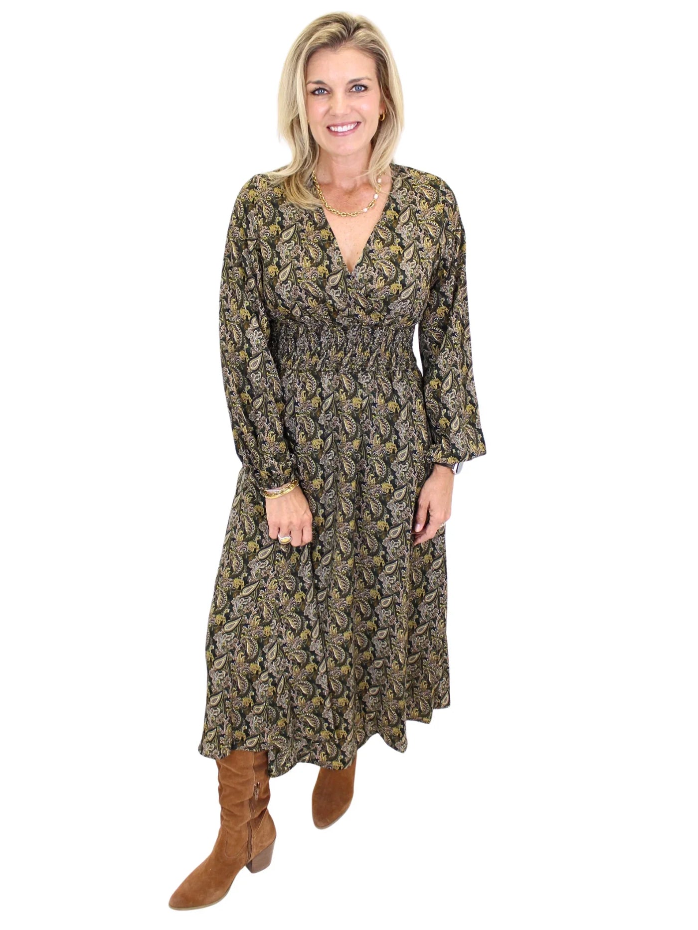 Woman wearing a long sleeve dark color paisley midi dress on white background, front.